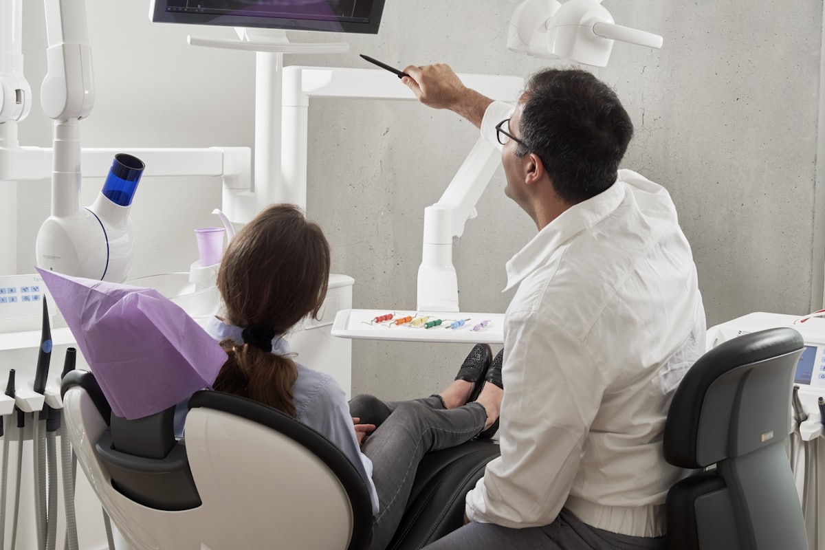 Dentist examining a patient in the treatment chair at Sunrise Dental Clinic
