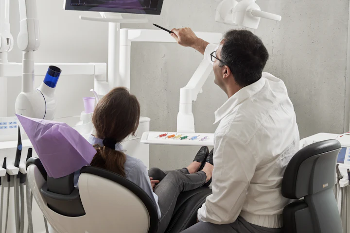 Dentist examining a patient in the treatment chair at Sunrise Dental Clinic