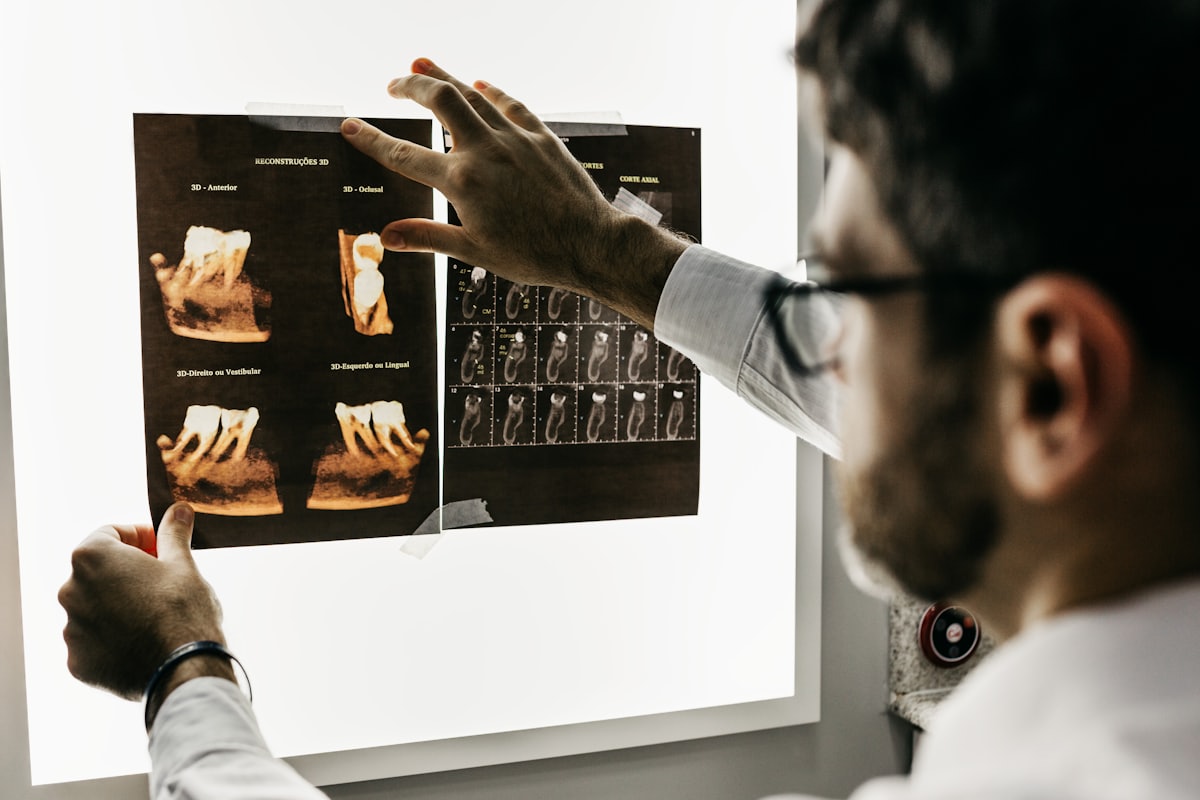 Dentist studying a set of dental X-rays on a lightbox